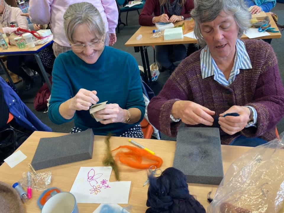 Two members making felt badges