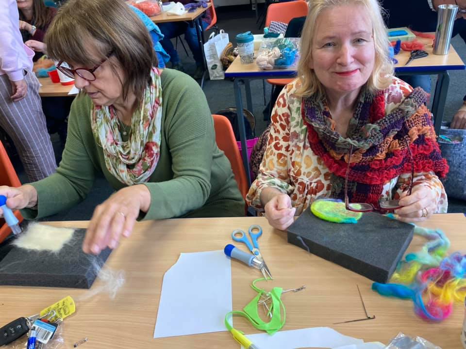 Two members making felt badges