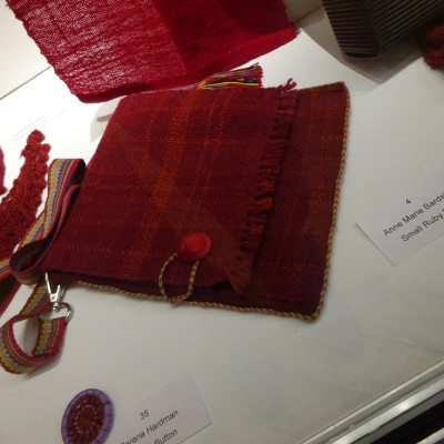 Small ruby-coloured woven bag.