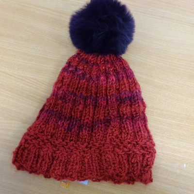 Red bobble hat with navy bobble