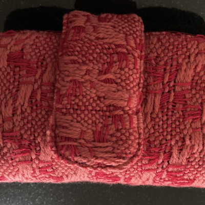 A small red and pink woven bag.
