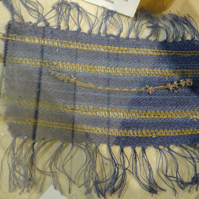 Lavender coloured table mat with stems of lavender woven in.