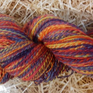 Multi-coloured spun yarn in yellows, blues, red, orange