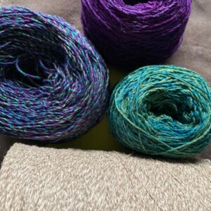 Balls of yarn in purple, green and blues.