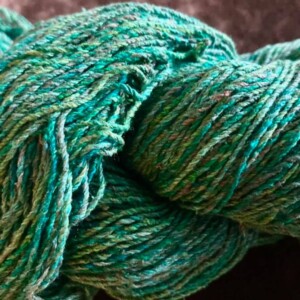 skein of silk yarn dyed green
